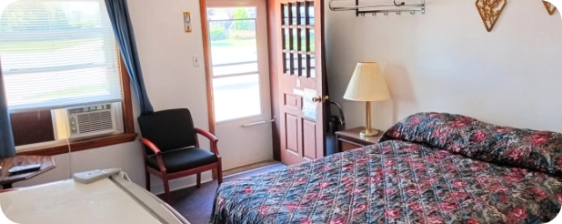 Motel room with AC, mini fridge and bed