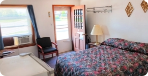 Motel room with AC, mini fridge and bed